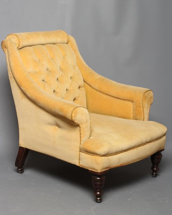 A VICTORIAN WALNUT FRAMED ARMCHAIR upholstered in yellow dralon Image