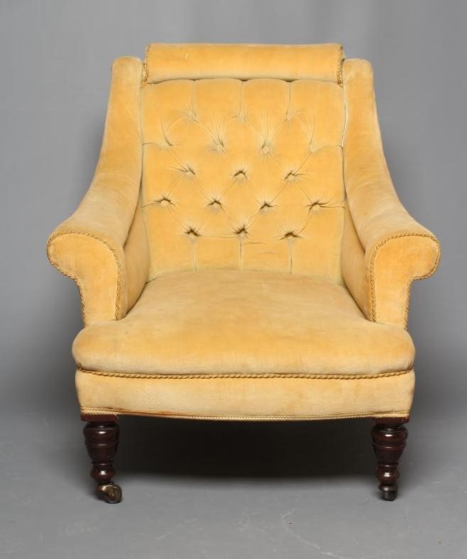 A VICTORIAN WALNUT FRAMED ARMCHAIR upholstered in yellow dralon Image