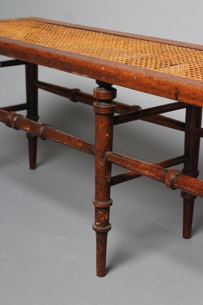 A VICTORIAN WALNUT(?) BENCH of rounded oblong form with caned seat Image