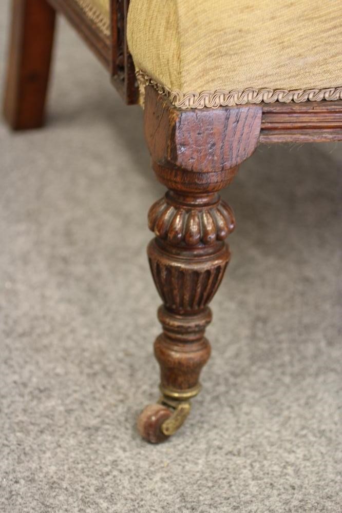 A GENTLEMAN'S VICTORIAN OAK FRAMED ARMCHAIR upholstered in gold chenille Image