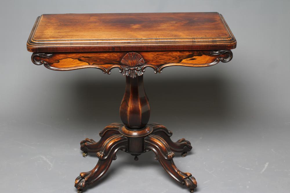 AN EARLY VICTORIAN ROSEWOOD FOLDING CARD TABLE of rounded oblong form Image