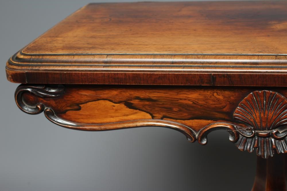 AN EARLY VICTORIAN ROSEWOOD FOLDING CARD TABLE of rounded oblong form Image