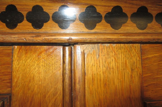A GOTHIC REVIVAL LIGHT OAK AND BLACK STENCILLED WARDROBE Image