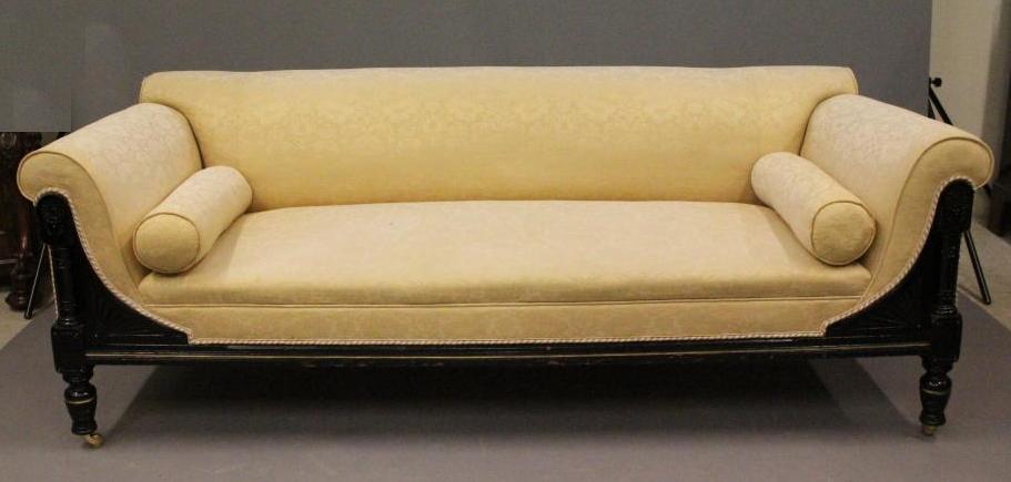 A VICTORIAN EBONISED AND PARCEL GILT CLUB SETTEE in the Aesthetic taste Image