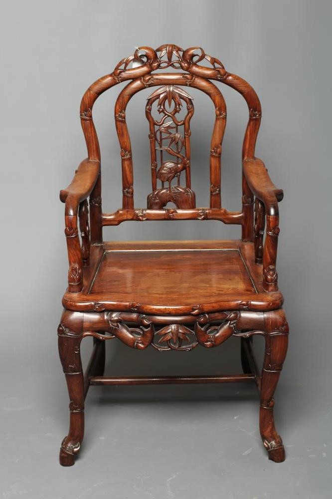 A CHINESE HARD WOOD ARMCHAIR carved throughout with bamboo Image