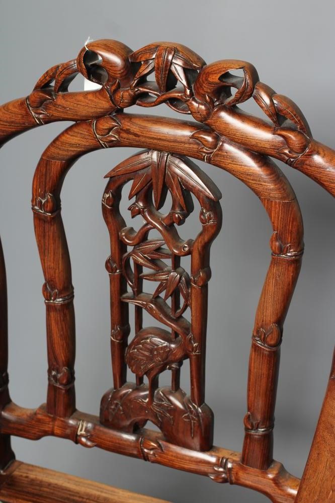 A CHINESE HARD WOOD ARMCHAIR carved throughout with bamboo Image