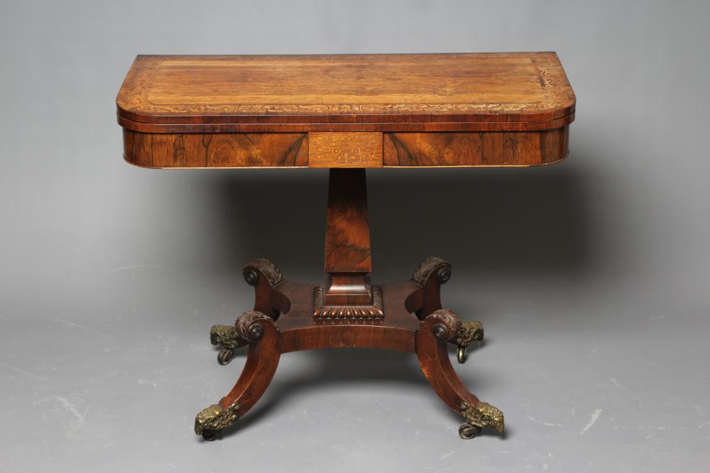 A REGENCY ROSEWOOD FOLDING TEA TABLE of rounded oblong form Image