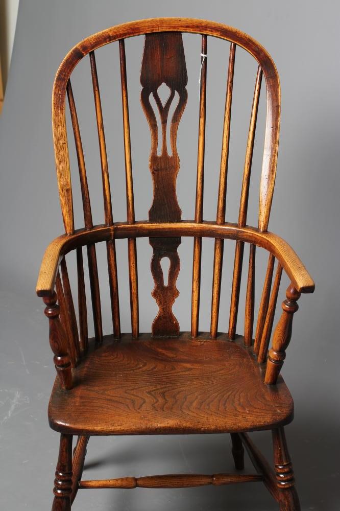 A  WINDSOR SPINDLE BACK ARMCHAIR in ash and elm Image