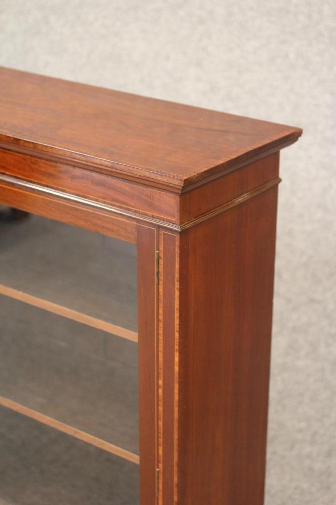 AN EDWARDIAN MAHOGANY BOOKCASE of shallow oblong form Image