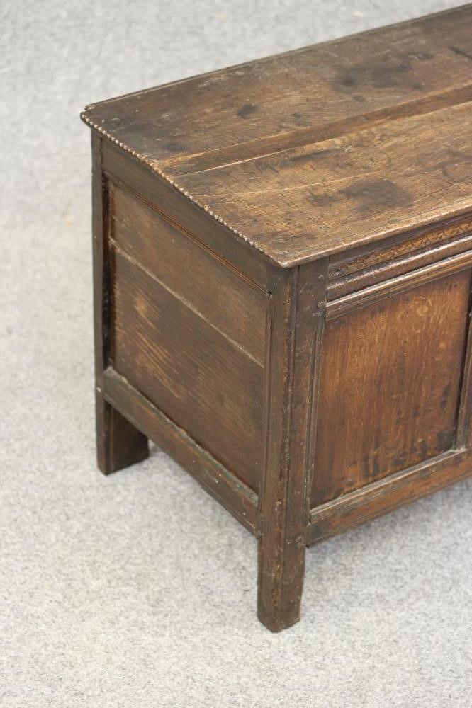AN OAK PANELLED COFFER Image