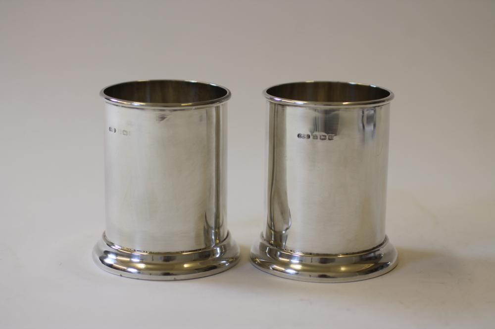 A PAIR OF SILVER SAUCE BOTTLE COASTERS Image