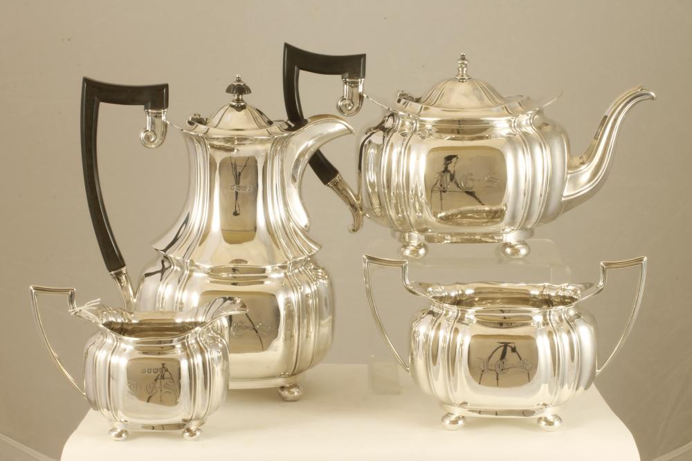 A SILVER COMPOSITE FOUR PIECE TEA AND COFFEE SERVICE Image