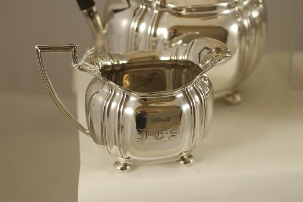 A SILVER COMPOSITE FOUR PIECE TEA AND COFFEE SERVICE Image