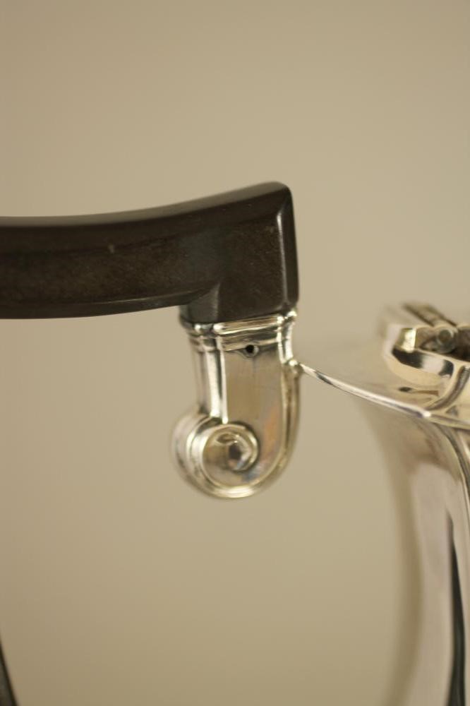 A SILVER COMPOSITE FOUR PIECE TEA AND COFFEE SERVICE Image