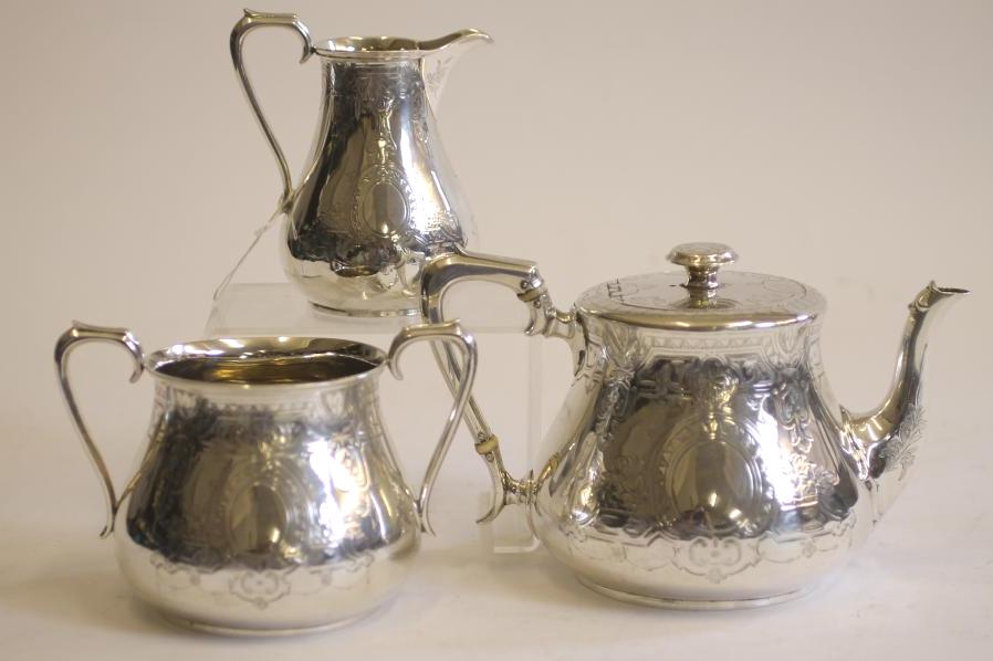 A COMPOSITE MID VICTORIAN SILVER THREE PIECE TEA SERVICE Image