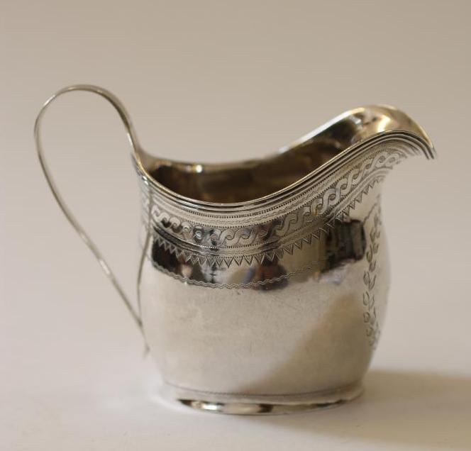 A GEORGE III SILVER HELMET MILK JUG Image