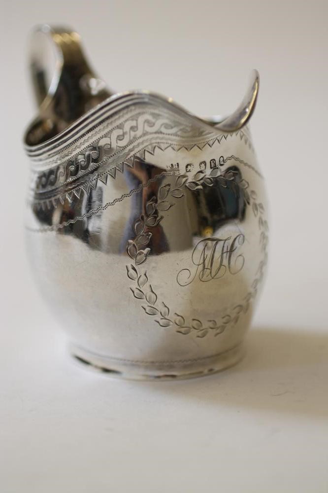 A GEORGE III SILVER HELMET MILK JUG Image