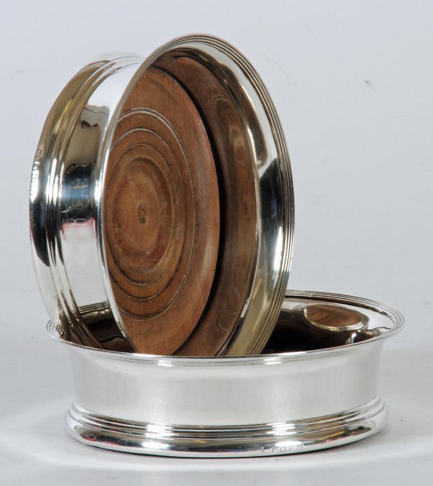 A PAIR OF GEORGE IV SILVER BOTTLE COASTERS Image