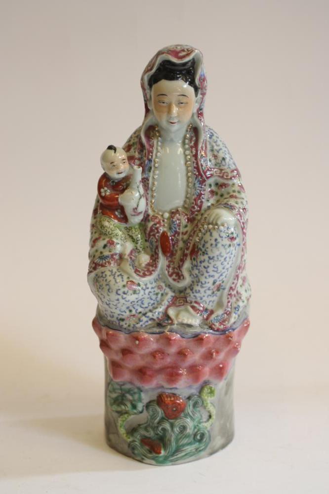 A CHINESE PORCELAIN FIGURE modelled as a deity wearing a gilded bead necklace Image