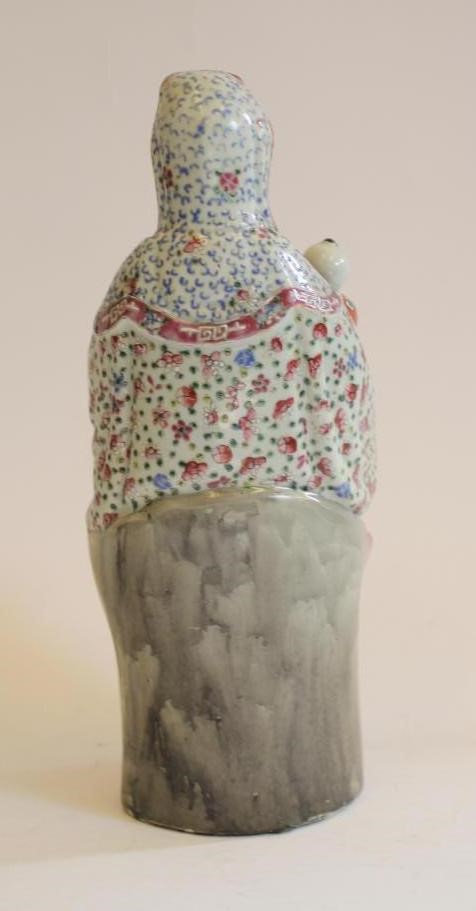 A CHINESE PORCELAIN FIGURE modelled as a deity wearing a gilded bead necklace Image