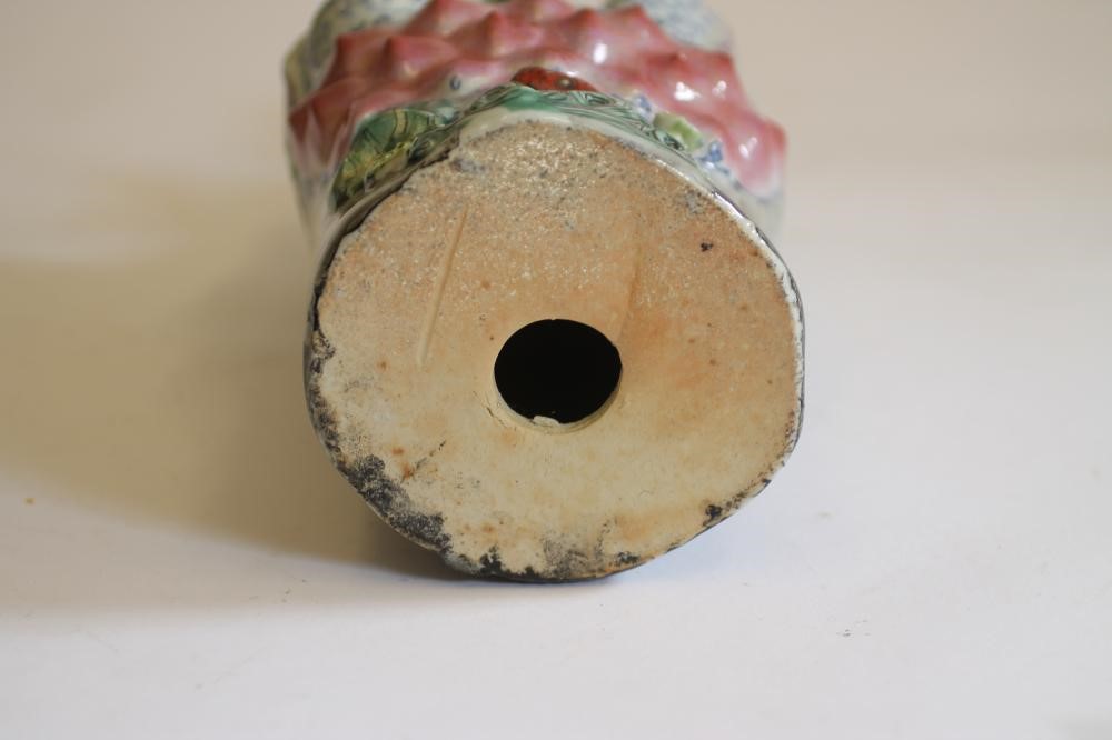 A CHINESE PORCELAIN FIGURE modelled as a deity wearing a gilded bead necklace Image