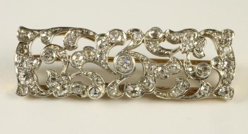 AN EDWARDIAN STYLE DIAMOND PLAQUE BROOCH of open scrolling foliate oblong form Image