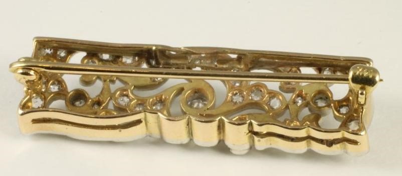 AN EDWARDIAN STYLE DIAMOND PLAQUE BROOCH of open scrolling foliate oblong form Image