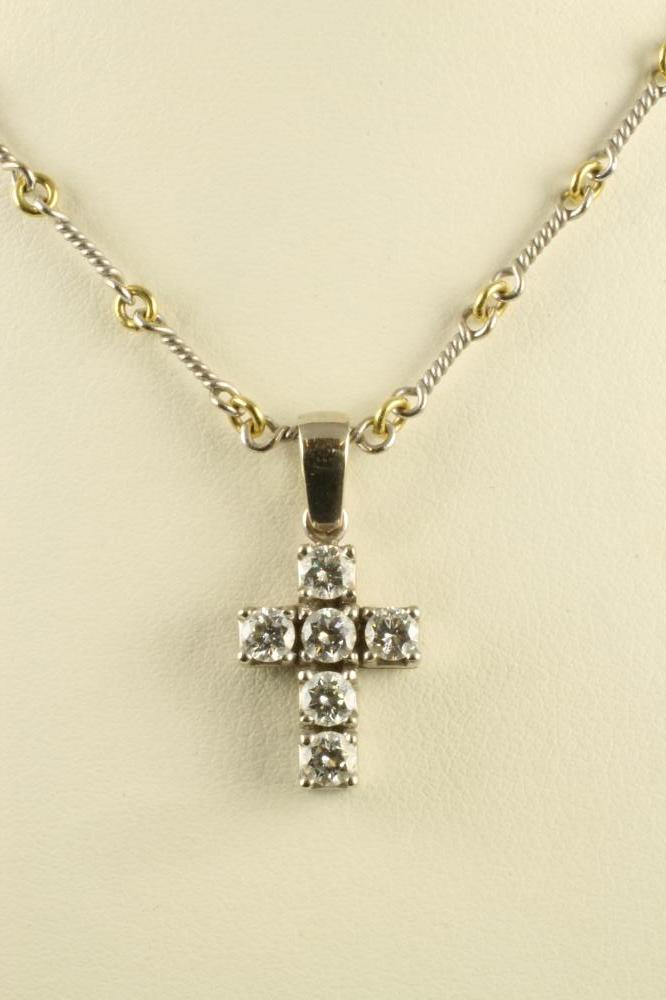 A DIAMOND CROSS PENDANT claw set with six brilliant cut stones to an 18ct gold white gold frame and Image