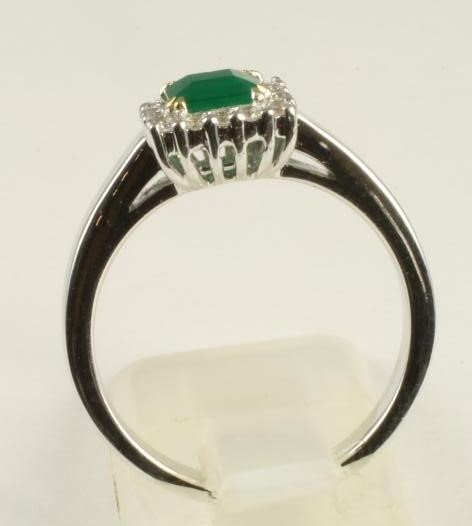 AN EMERALD AND DIAMOND RING Image