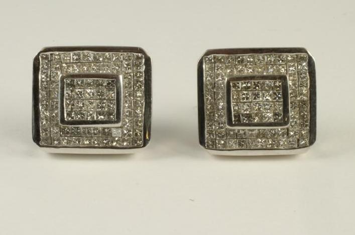A PAIR OF DIAMOND STUD EARRINGS of canted oblong form pave set with numerous small square cut stones Image