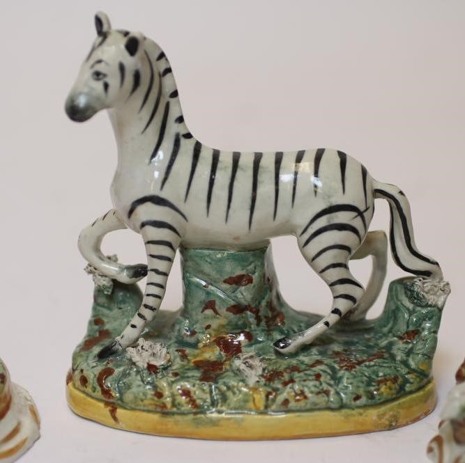 TWO LATE VICTORIAN STAFFORDSHIRE POTTERY MODELS OF RECUMBENT GREYHOUNDS Image