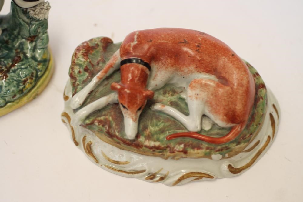 TWO LATE VICTORIAN STAFFORDSHIRE POTTERY MODELS OF RECUMBENT GREYHOUNDS Image