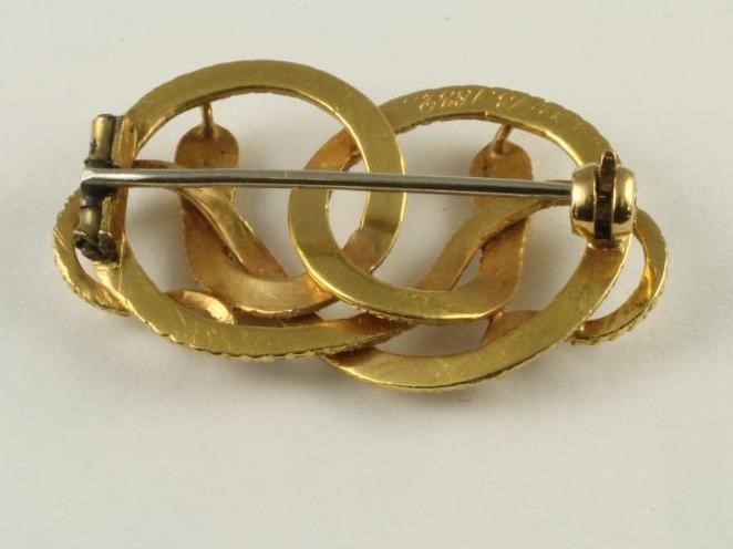 A WILLIAM IV GOLD BROOCH as two entwined serpents with chased scales and features Image