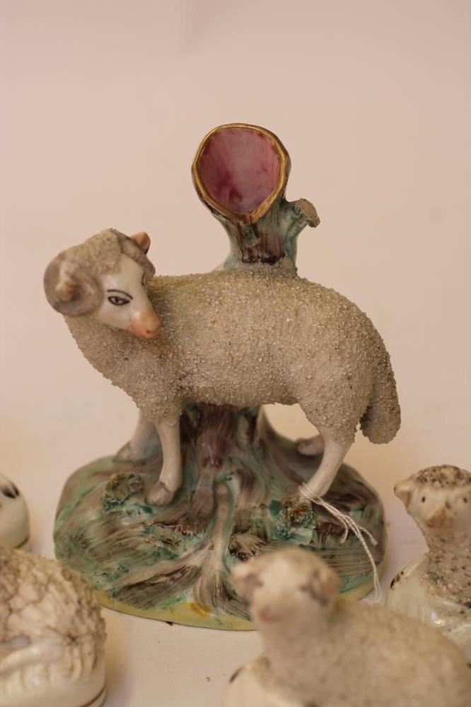 A COLLECTION OF VICTORIAN AND LATER STAFFORDSHIRE POTTERY MODELS of recumbent sheep Image