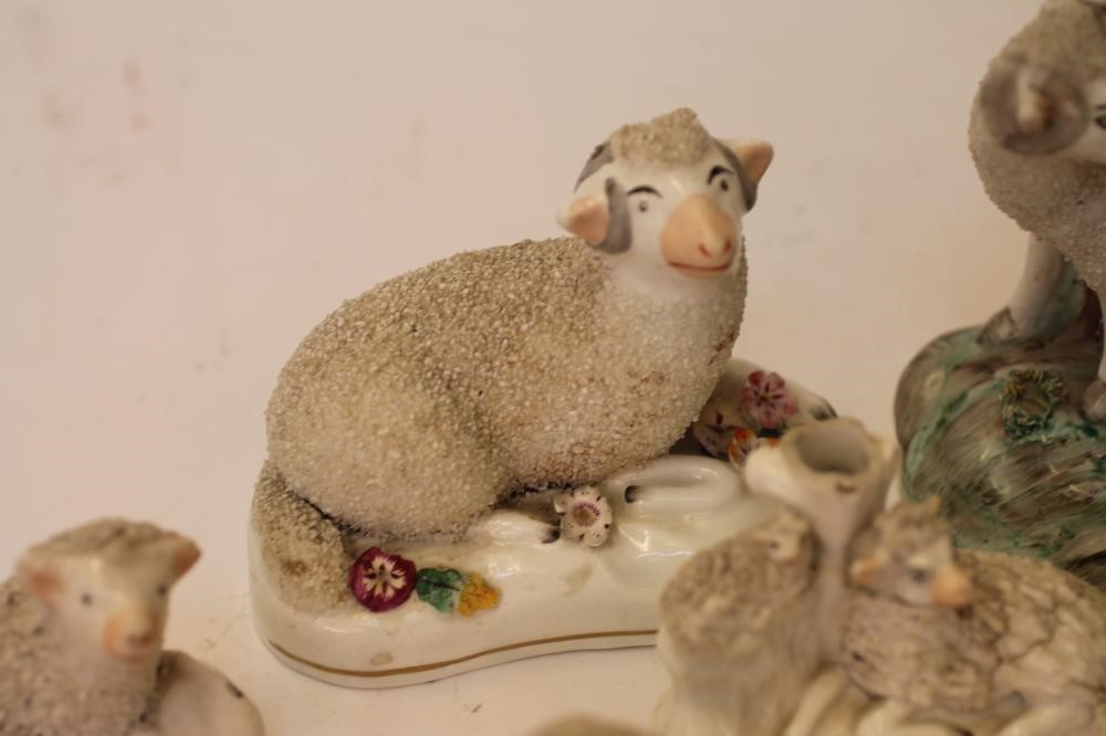 A COLLECTION OF VICTORIAN AND LATER STAFFORDSHIRE POTTERY MODELS of recumbent sheep Image
