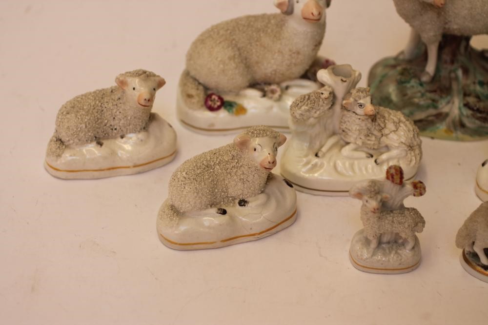 A COLLECTION OF VICTORIAN AND LATER STAFFORDSHIRE POTTERY MODELS of recumbent sheep Image