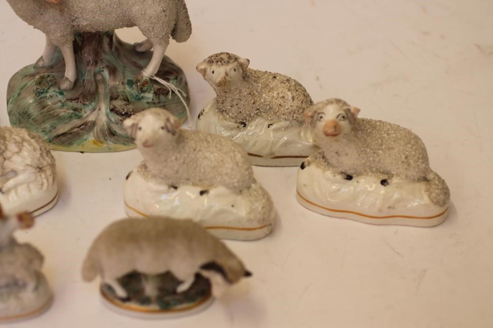 A COLLECTION OF VICTORIAN AND LATER STAFFORDSHIRE POTTERY MODELS of recumbent sheep Image