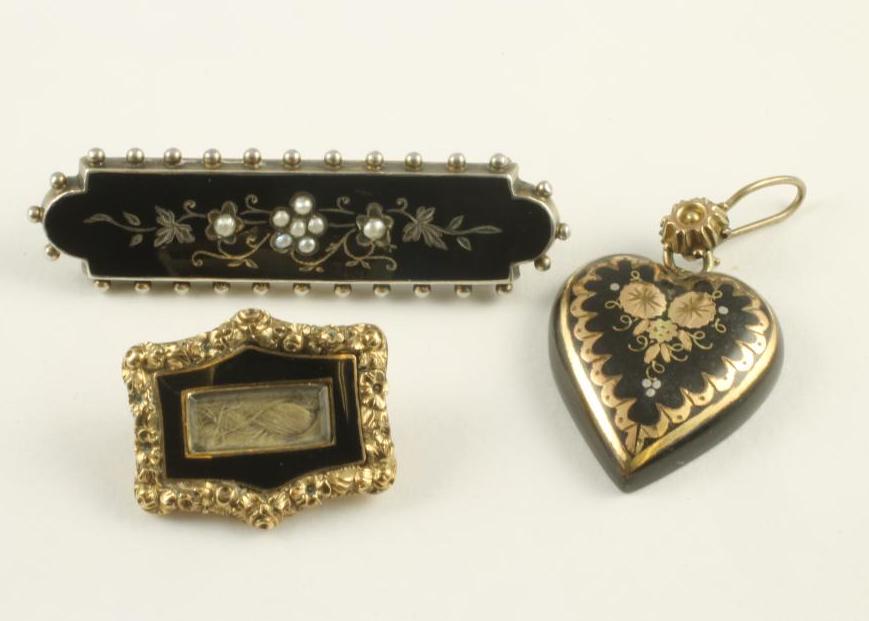 A GEORGE III MOURNING BROOCH of shaped oblong form with foliate chased border enclosing black enamel Image