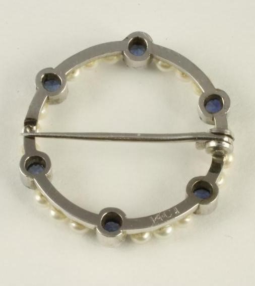 A SEED PEARL AND SAPPHIRE CIRCLET BROOCH Image