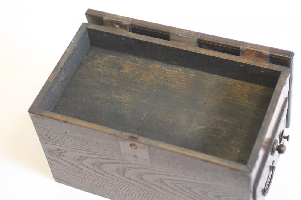 A CHINESE STAINED WOOD WRITING BOX of oblong form with copper mounts and loop handles Image