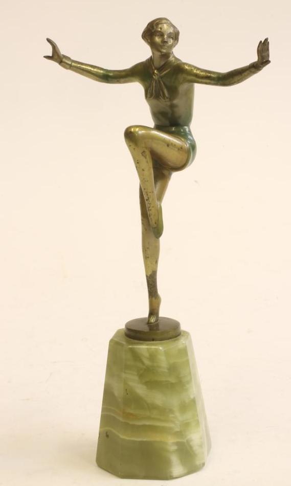 AN ART DECO COLD PAINTED BRONZE FIGURE of a young lady standing on her right leg with arms Image