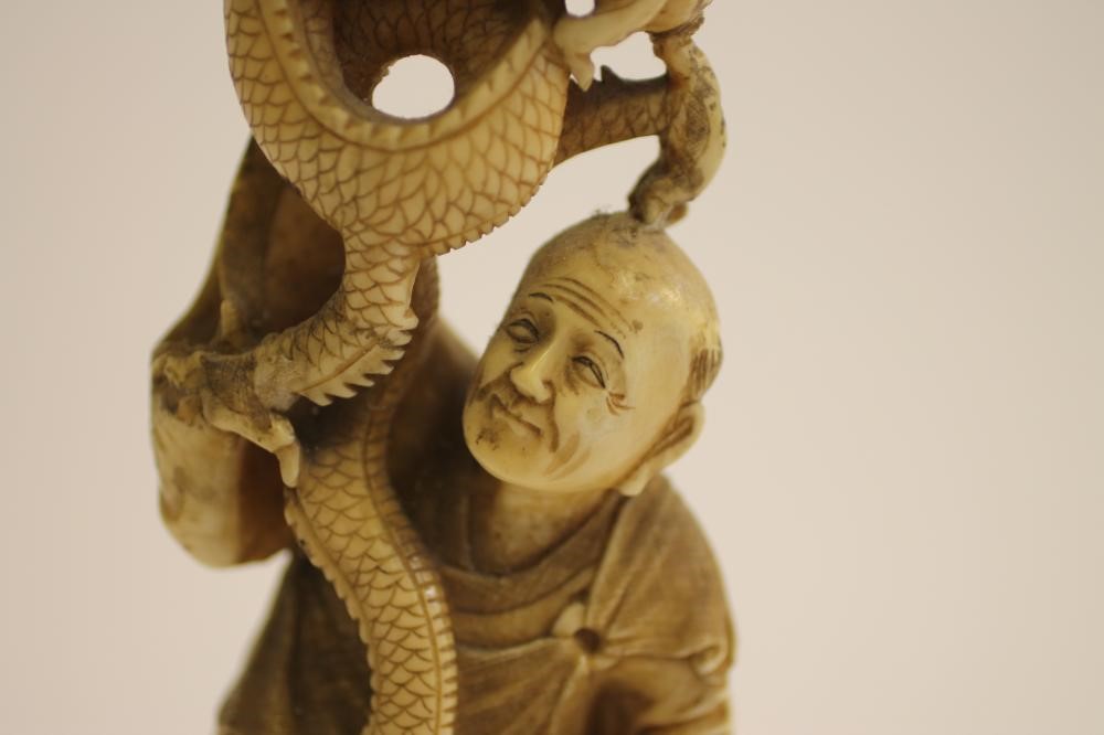 A JAPANESE CARVED IVORY FIGURE GROUP Image