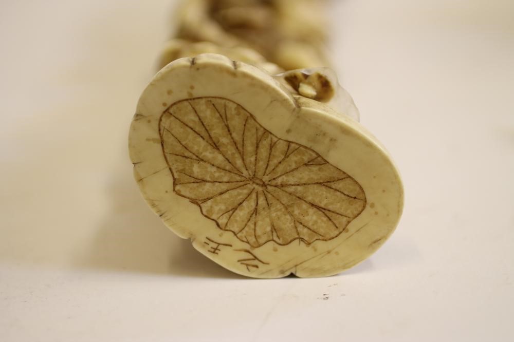 A JAPANESE CARVED IVORY FIGURE GROUP Image