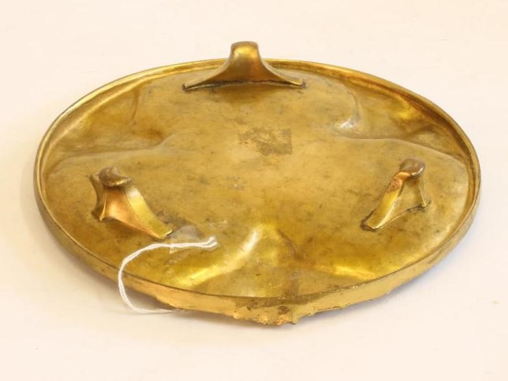 AN ART NOUVEAU GILT METAL DISH of circular form raised upon three bracket feet Image