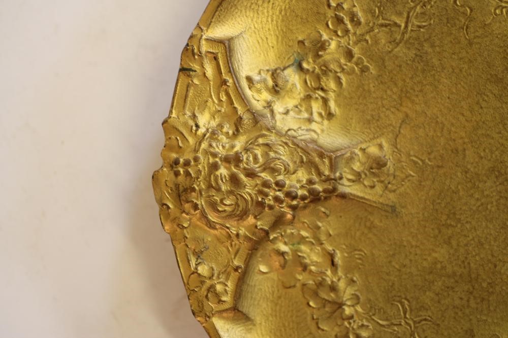AN ART NOUVEAU GILT METAL DISH of circular form raised upon three bracket feet Image