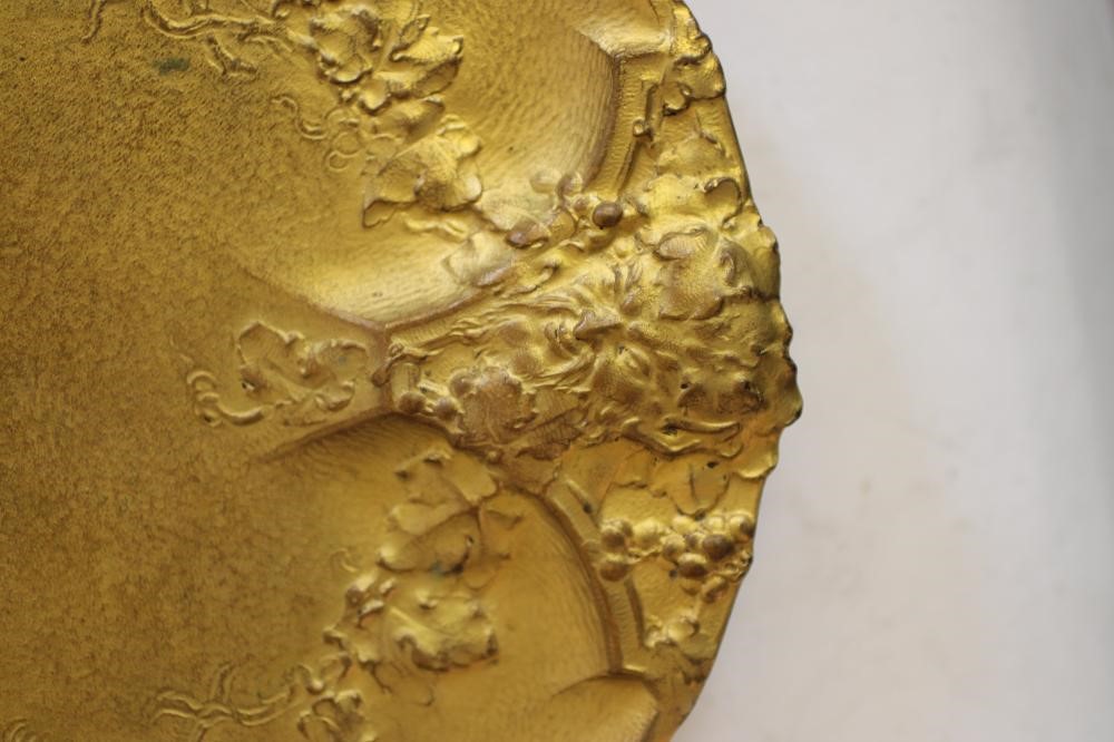AN ART NOUVEAU GILT METAL DISH of circular form raised upon three bracket feet Image