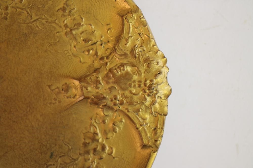 AN ART NOUVEAU GILT METAL DISH of circular form raised upon three bracket feet Image