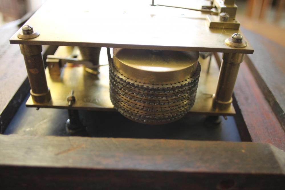 A MAHOGANY WALL CLOCK Image