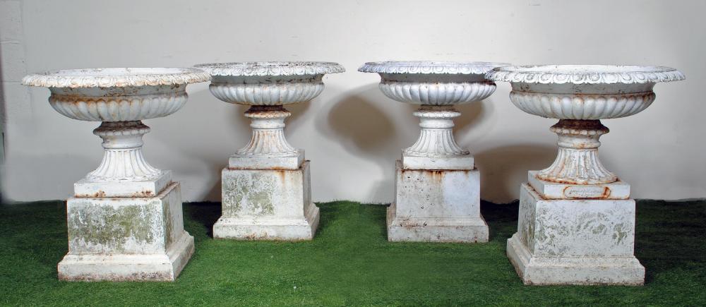 A SET OF FOUR VICTORIAN CAST IRON URNS of half fluted campana form with ovolu moulded rim Image