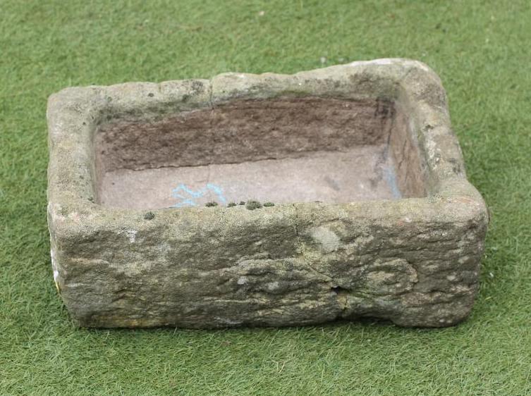 A SMALL SANDSTONE TROUGH of rough hewn oblong form Image